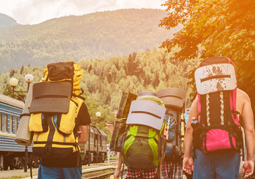 Tourists,Or,Travelers,With,Backpacks,On,Their,Back,Travel,To