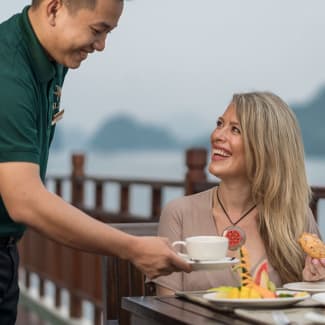 Waiter serving coffee al fresco
